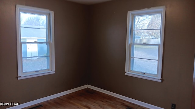 spare room featuring wood-type flooring