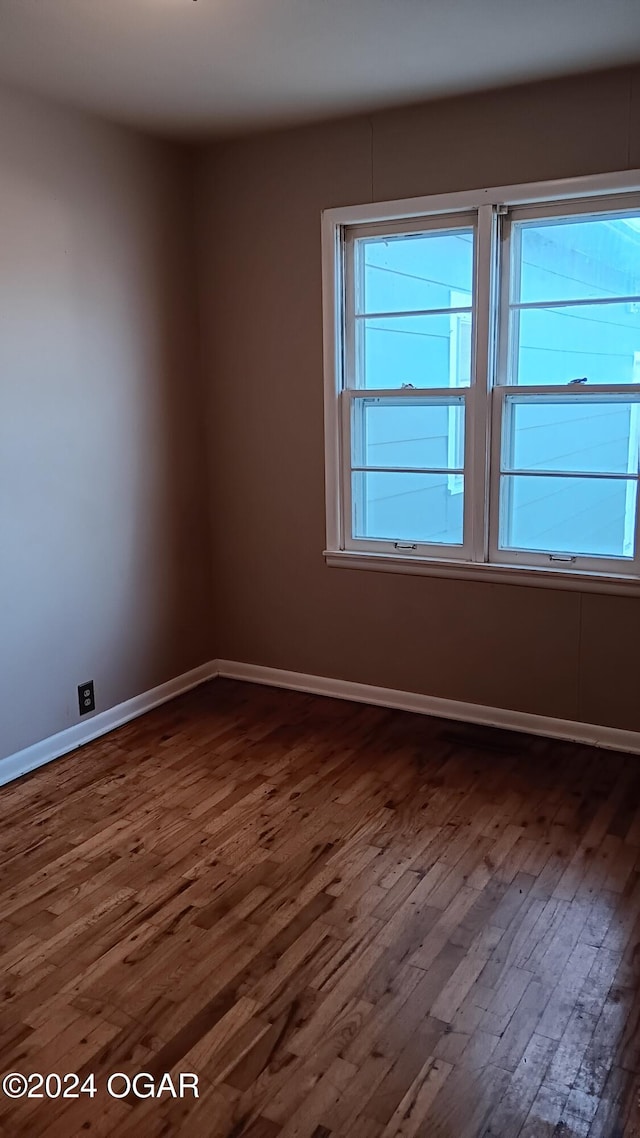 spare room featuring dark hardwood / wood-style flooring