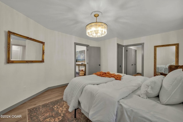 bedroom featuring hardwood / wood-style floors and a notable chandelier