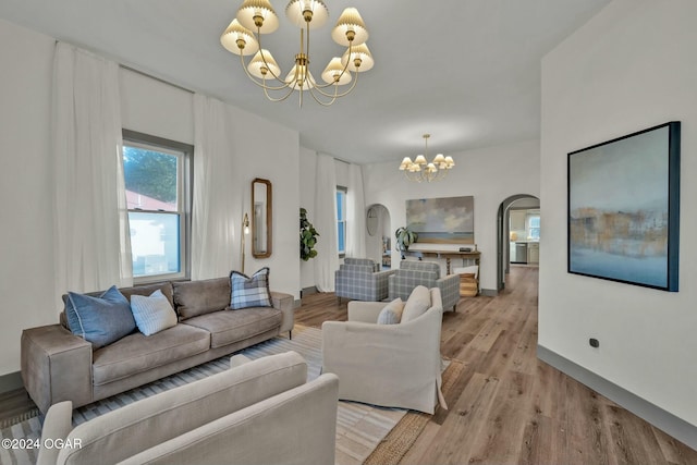 living room featuring light hardwood / wood-style floors and a notable chandelier