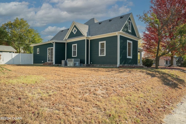 back of property featuring a lawn