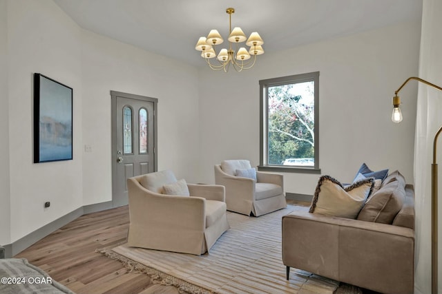 living room with light wood-type flooring and a notable chandelier