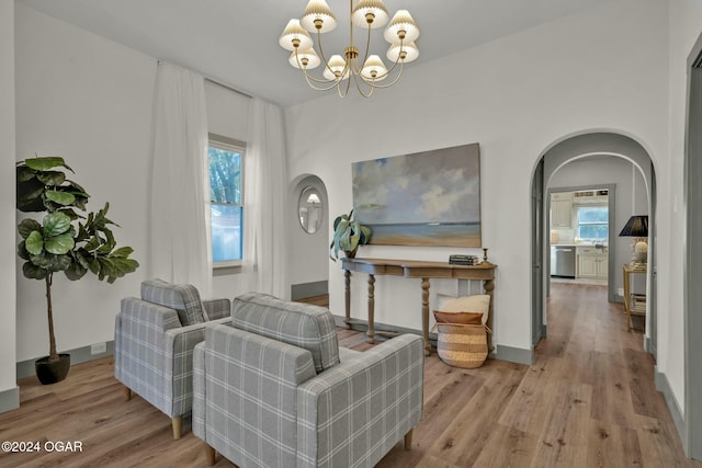 living room with a chandelier and light hardwood / wood-style flooring