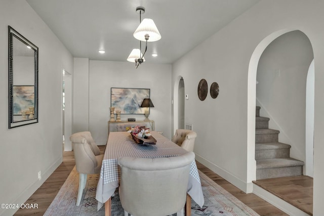 dining space with hardwood / wood-style flooring