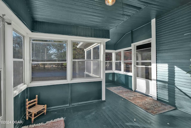 unfurnished sunroom featuring lofted ceiling