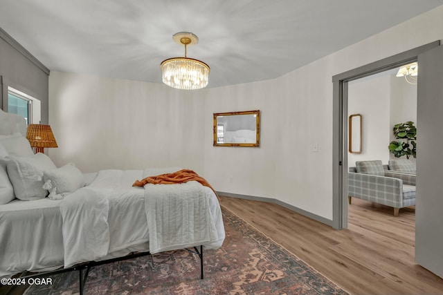 bedroom featuring hardwood / wood-style floors and a notable chandelier