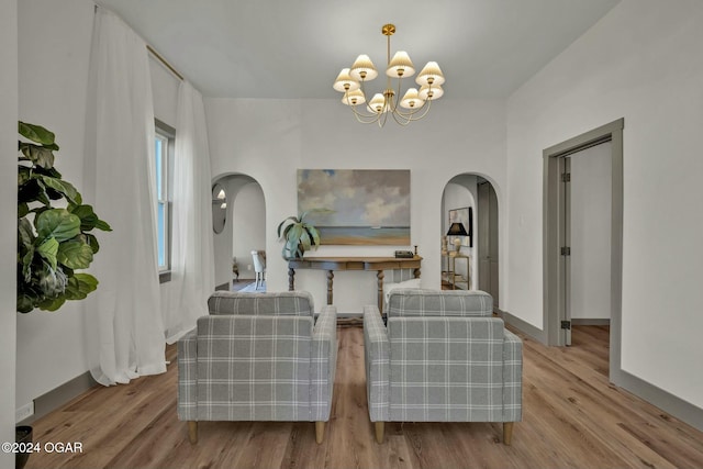 living area with a chandelier and light wood-type flooring