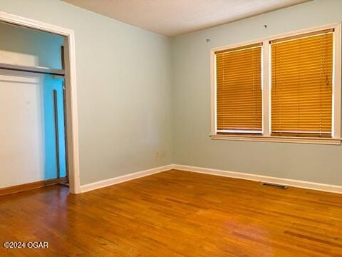 unfurnished bedroom with wood-type flooring