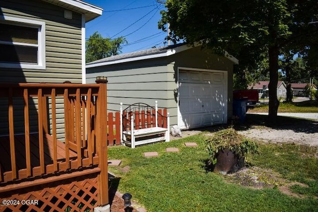 exterior space featuring an outbuilding, a garage, and a deck