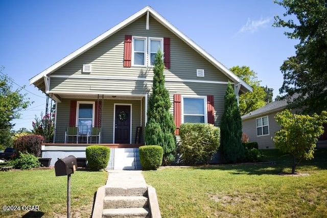 view of front of home with covered porch and a front yard