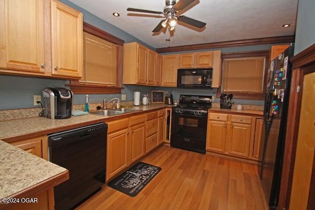 kitchen featuring black appliances, sink, light hardwood / wood-style flooring, ceiling fan, and ornamental molding