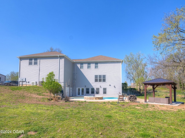 back of house featuring a gazebo, a yard, and a patio