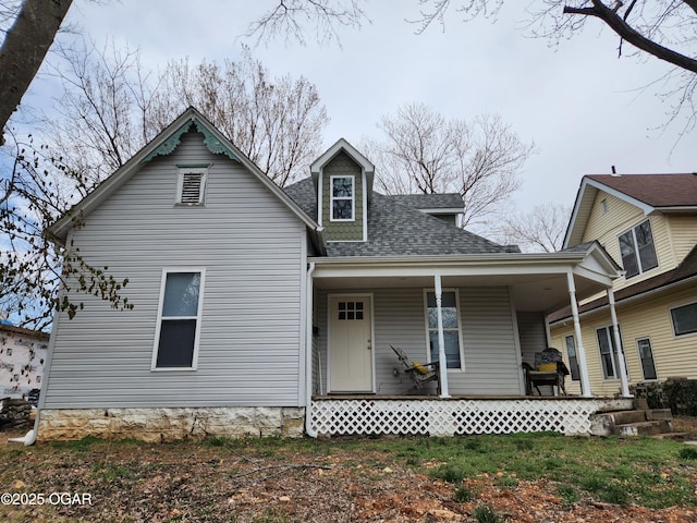 view of front facade featuring a porch and a shingled roof