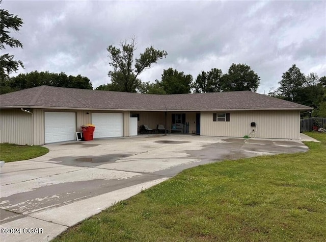 single story home with a garage and a front lawn