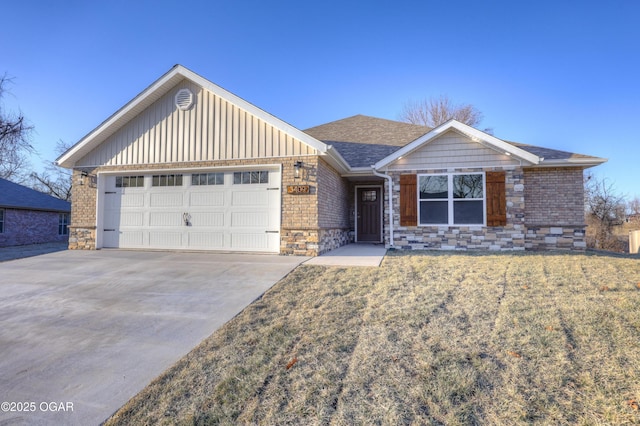 view of front of home with a garage and a front lawn