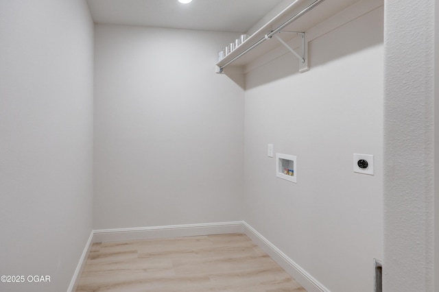 washroom featuring hookup for a washing machine, electric dryer hookup, and light wood-type flooring