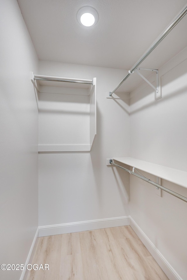 spacious closet featuring hardwood / wood-style floors