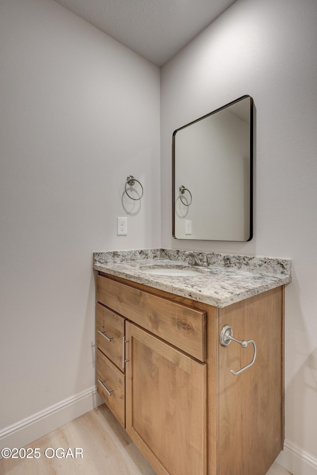 bathroom featuring hardwood / wood-style flooring and vanity