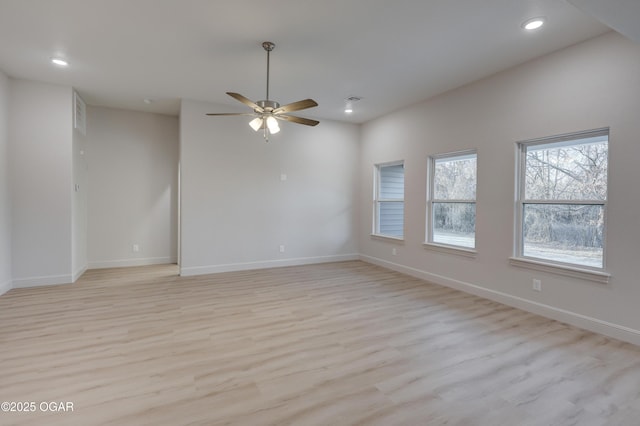 empty room with light hardwood / wood-style floors and ceiling fan