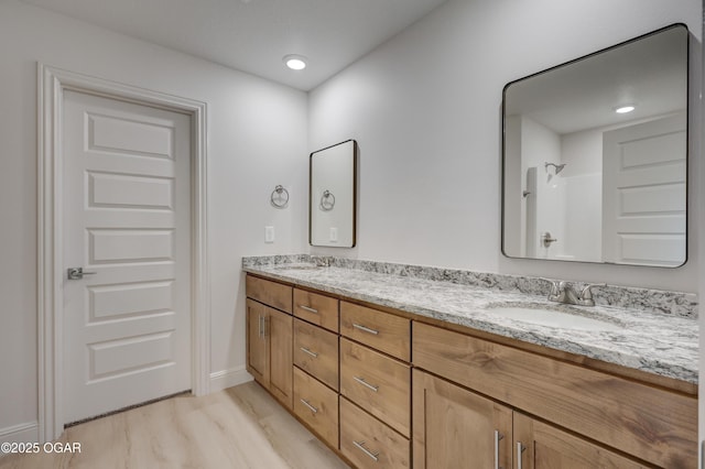 bathroom with hardwood / wood-style flooring, a shower, and vanity