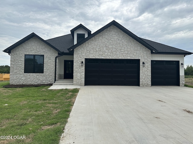 view of front facade with a garage and a front lawn