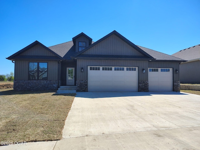 craftsman-style house with concrete driveway, stone siding, an attached garage, a front yard, and a shingled roof