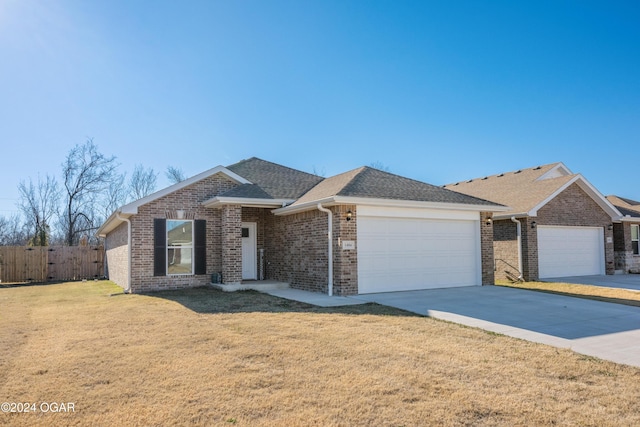 single story home with a garage and a front yard