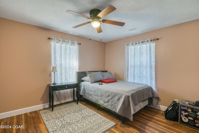 bedroom featuring ceiling fan, a textured ceiling, and hardwood / wood-style flooring