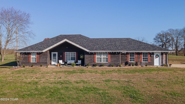 ranch-style home featuring a front yard