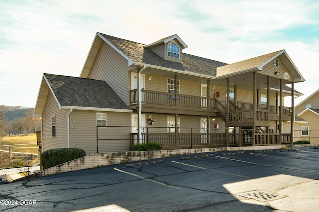 view of property featuring uncovered parking and fence