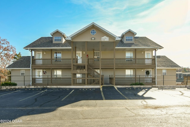 view of property with uncovered parking and fence