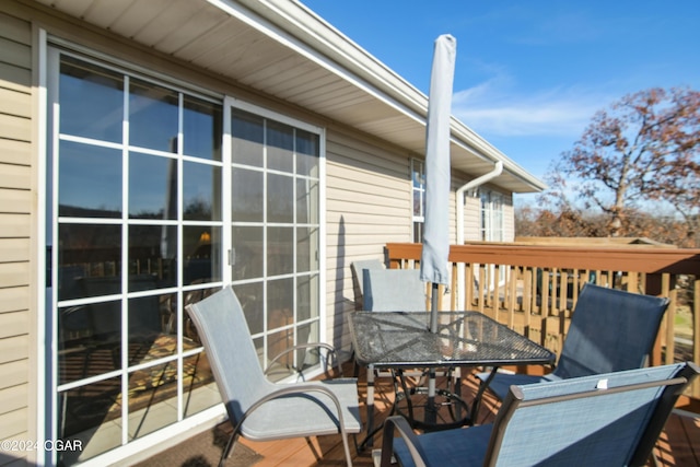 wooden terrace featuring outdoor dining area