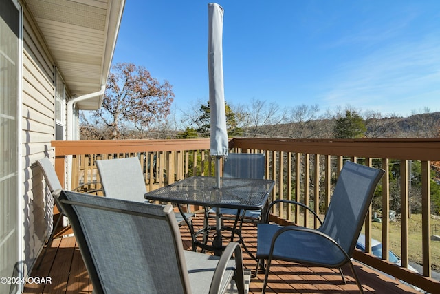 wooden terrace featuring outdoor dining area