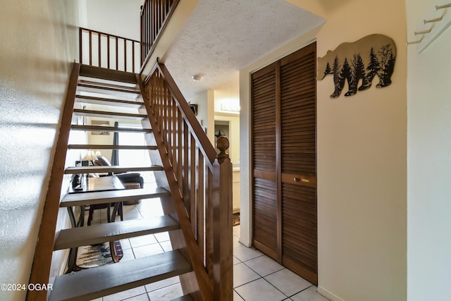 staircase featuring tile patterned flooring