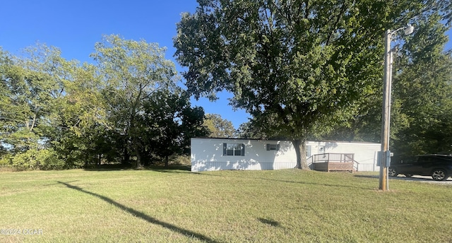 view of yard featuring a wooden deck