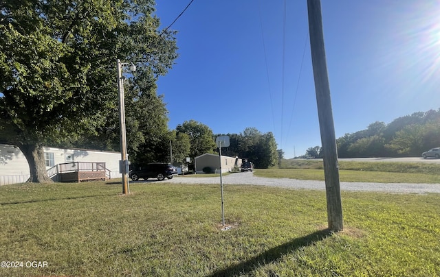 view of yard with a deck and a carport