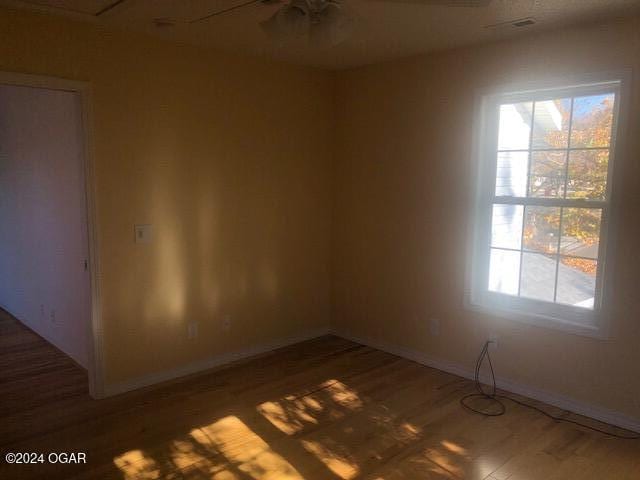 unfurnished room featuring baseboards and wood finished floors