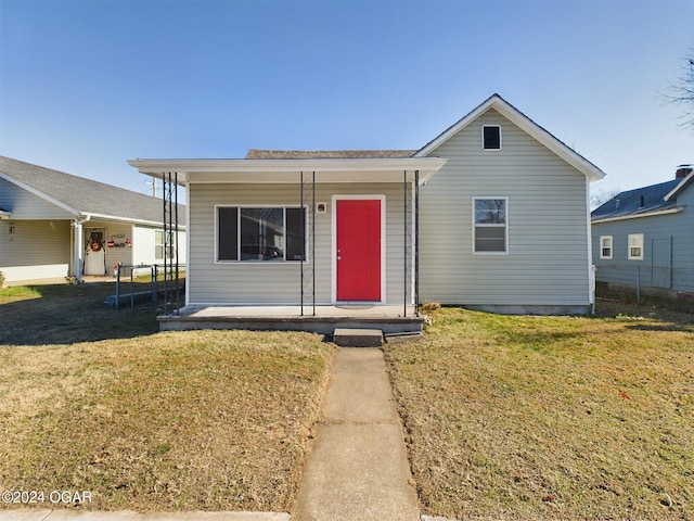 view of front of house with a front yard and covered porch