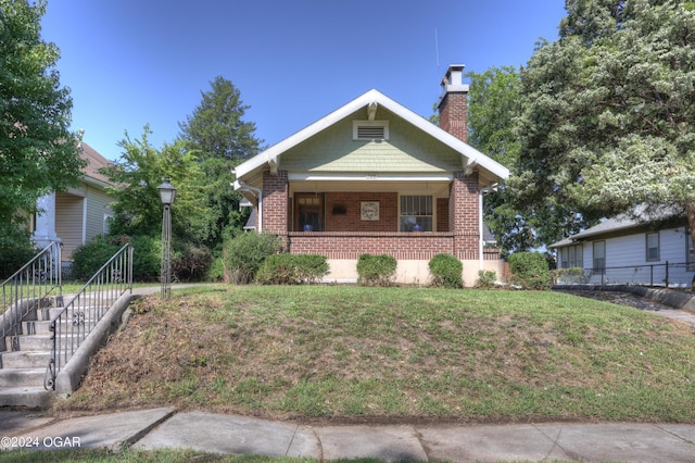 bungalow-style house featuring a front yard