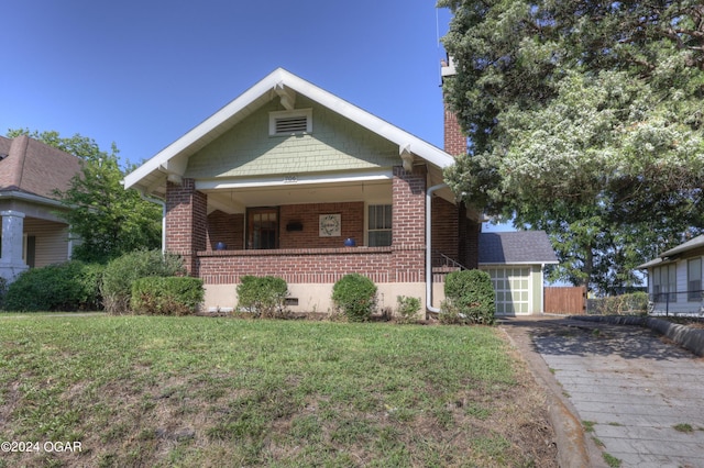 view of front of house with covered porch and a front yard