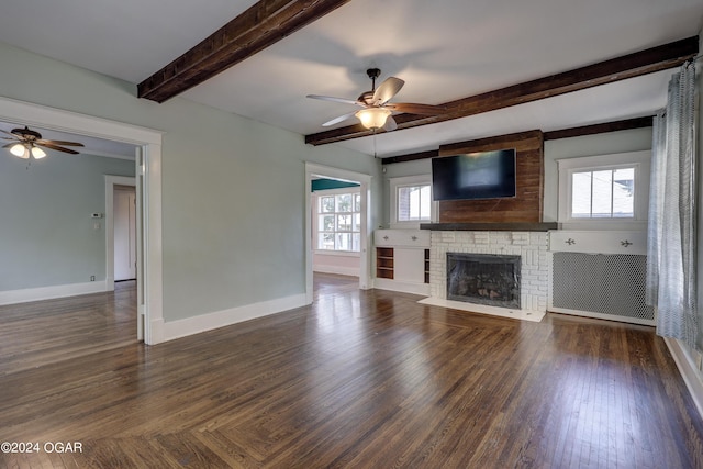 unfurnished living room with beamed ceiling, plenty of natural light, and ceiling fan