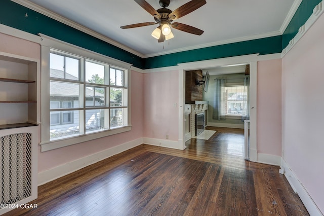 interior space featuring crown molding, dark wood-type flooring, ceiling fan, and a healthy amount of sunlight