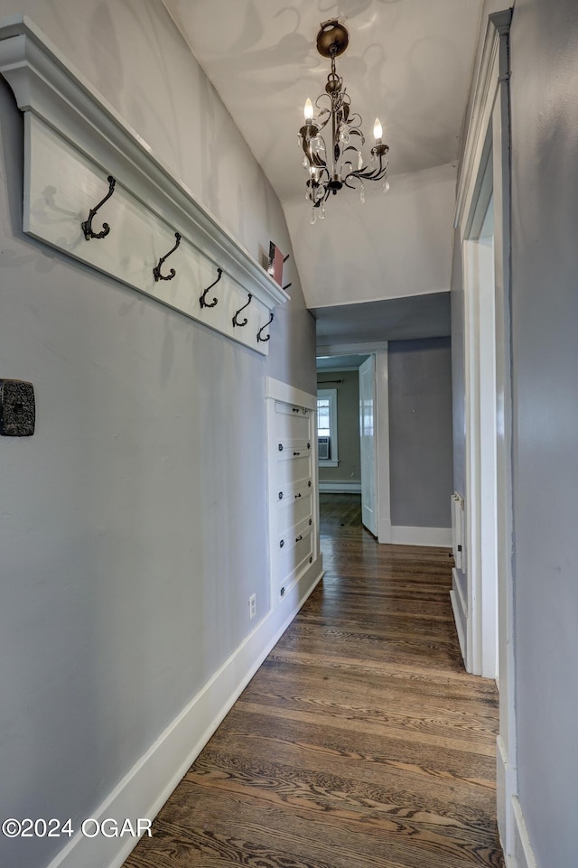 mudroom with a chandelier, lofted ceiling, and dark wood-type flooring