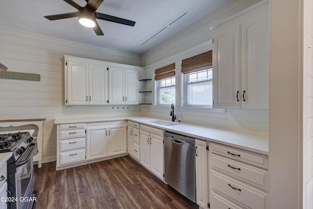 kitchen featuring wood walls, stove, white cabinets, and stainless steel dishwasher