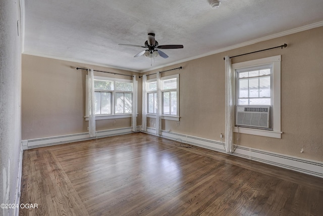 spare room featuring ceiling fan, plenty of natural light, a baseboard heating unit, and hardwood / wood-style flooring