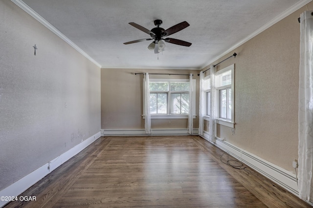 unfurnished room with ceiling fan, wood-type flooring, crown molding, and a baseboard heating unit