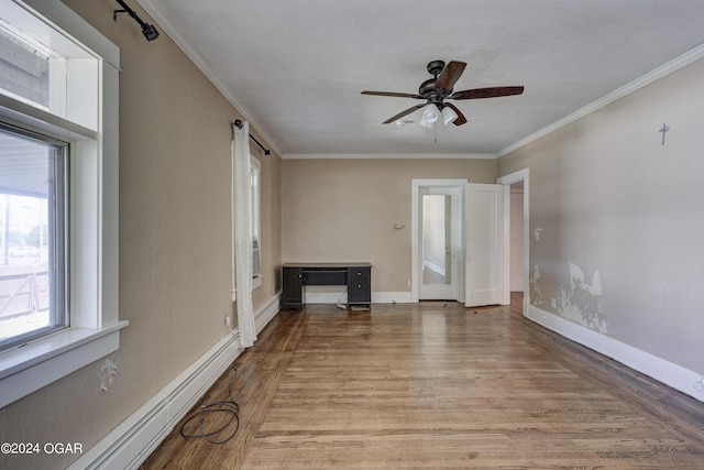 unfurnished living room featuring crown molding, light hardwood / wood-style flooring, ceiling fan, and a baseboard heating unit