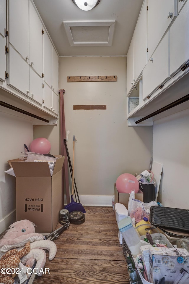 clothes washing area featuring dark hardwood / wood-style flooring