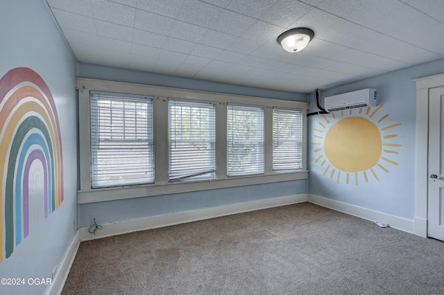 spare room featuring carpet floors and a wall mounted AC