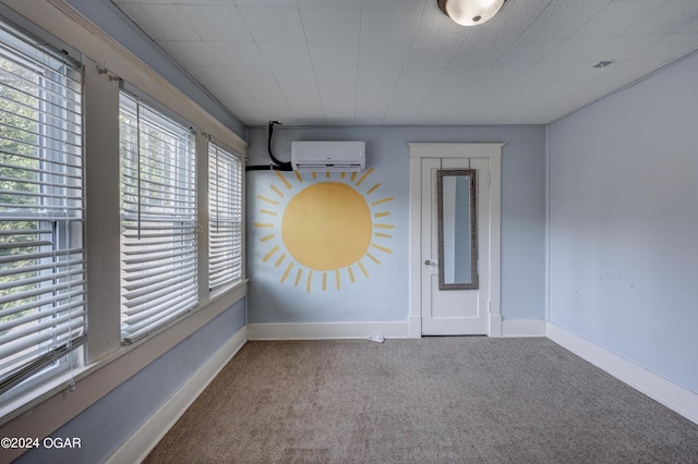 carpeted empty room with a wall unit AC